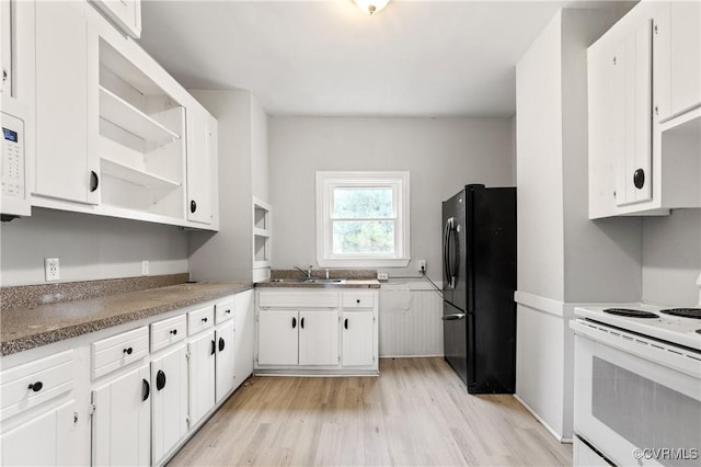 kitchen with light wood-style flooring, white appliances, a sink, white cabinets, and open shelves