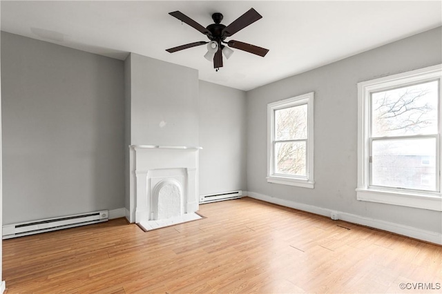 unfurnished living room featuring a baseboard heating unit, a fireplace with flush hearth, baseboards, and light wood finished floors