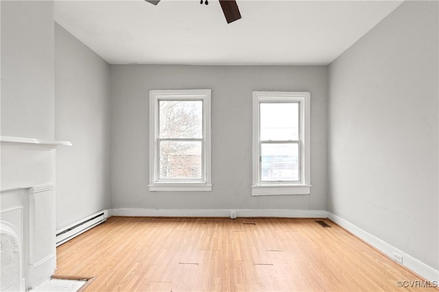 unfurnished living room with a baseboard radiator, baseboards, light wood-style flooring, and a ceiling fan