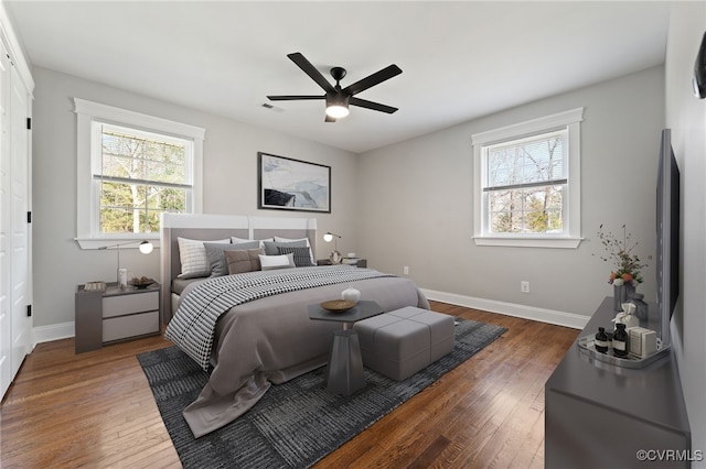 bedroom featuring wood-type flooring, visible vents, and baseboards