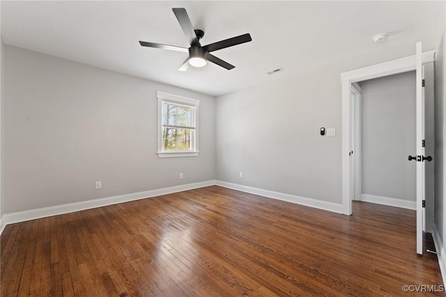 unfurnished room with wood-type flooring, visible vents, ceiling fan, and baseboards