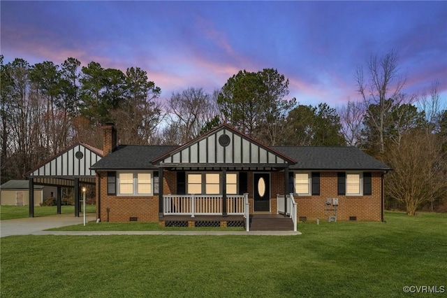 view of front facade featuring covered porch, brick siding, crawl space, and a front yard