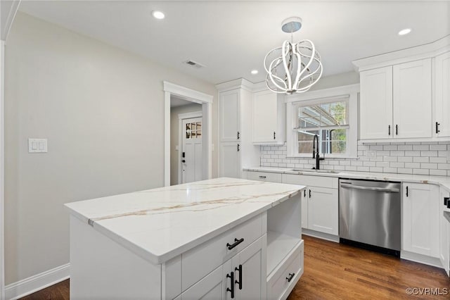 kitchen with tasteful backsplash, a sink, stainless steel dishwasher, and dark wood-style floors