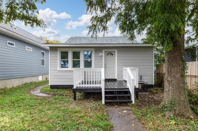 exterior space with fence and a deck