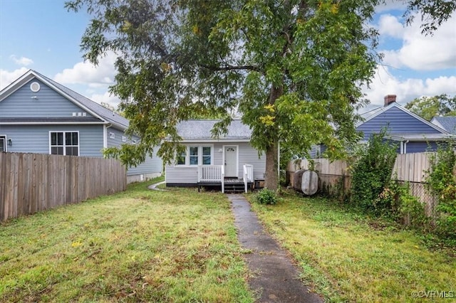 back of house with a yard and fence