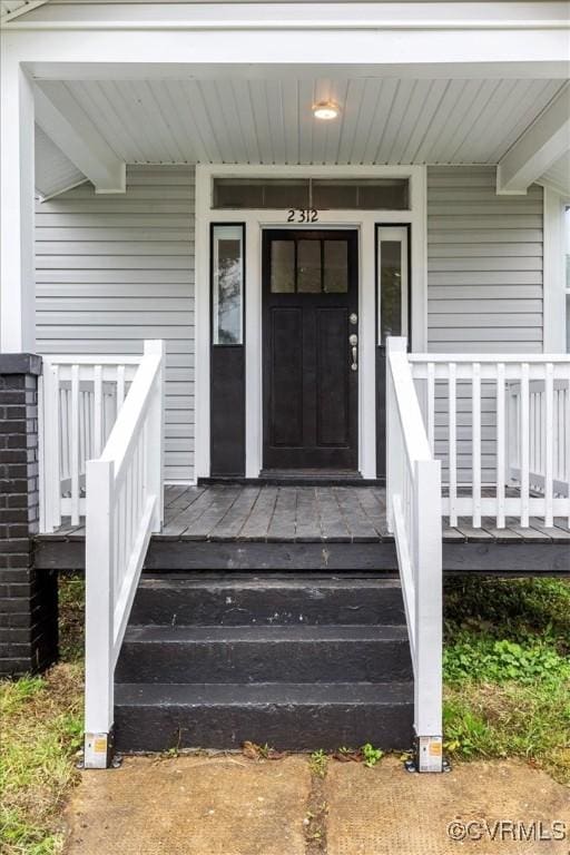 doorway to property featuring a porch