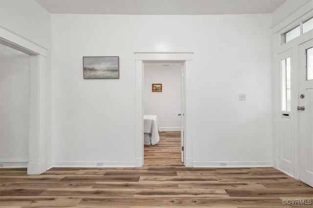 entrance foyer featuring wood finished floors and baseboards