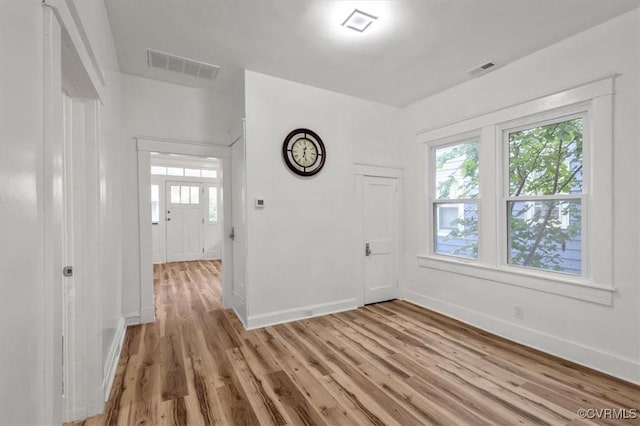 entryway with a healthy amount of sunlight, visible vents, baseboards, and light wood finished floors