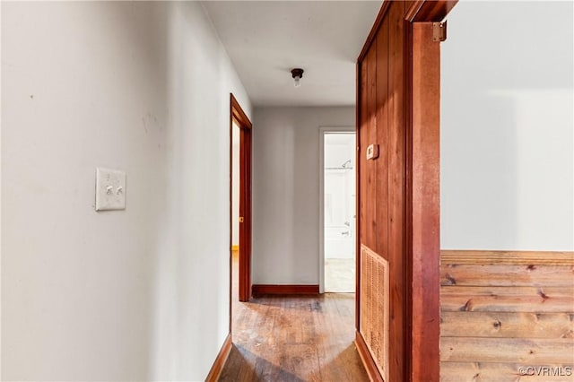 hall featuring visible vents and wood finished floors