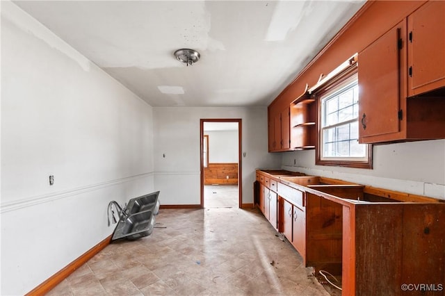 kitchen featuring baseboards and open shelves