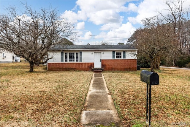 view of front of property with entry steps, a front lawn, and brick siding