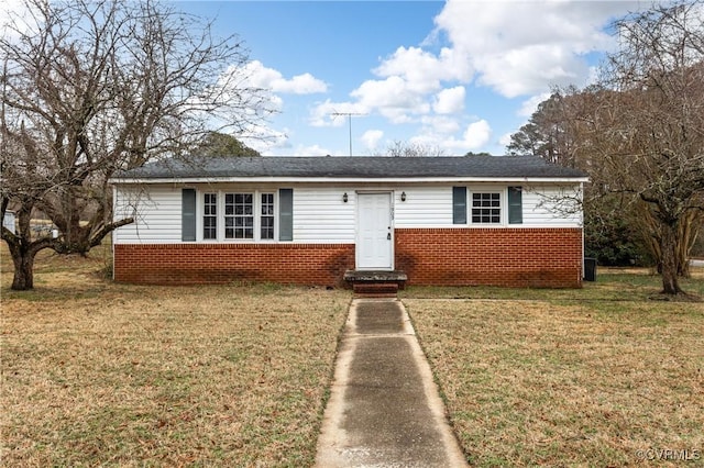 view of front of property with brick siding and a front lawn