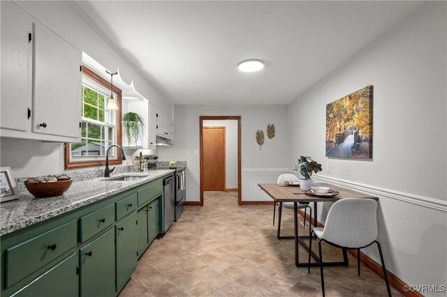 1909 Dinwiddie Ave, Hopewell, VA 23860 - kitchen with green cabinetry, white cabinetry, appliances with stainless steel finishes, and light stone countertops
