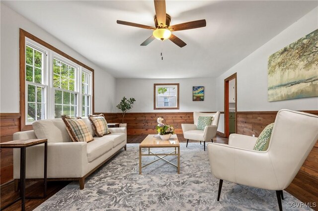 1909 Dinwiddie Ave, Hopewell, VA 23860 - living area with wainscoting, wood walls, a ceiling fan, and wood finished floors