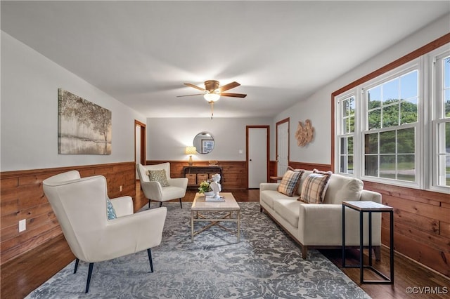 1909 Dinwiddie Ave, Hopewell, VA 23860 - living room with a wainscoted wall, wooden walls, wood finished floors, and a ceiling fan
