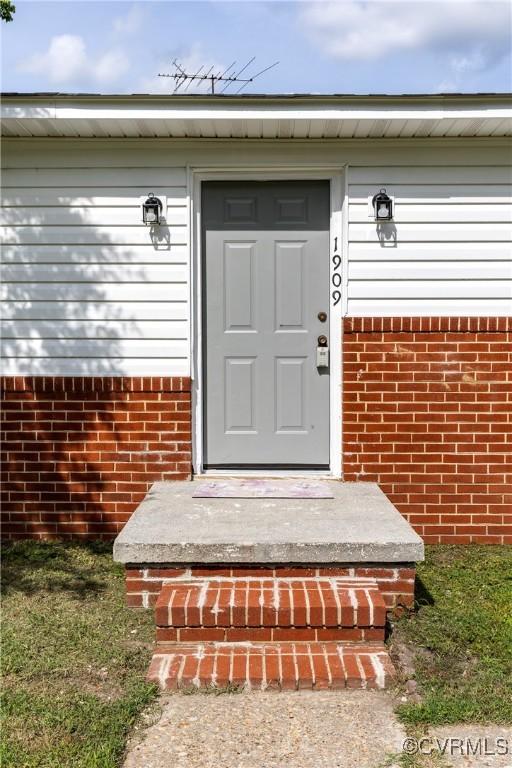 1909 Dinwiddie Ave, Hopewell, VA 23860 - doorway to property featuring brick siding