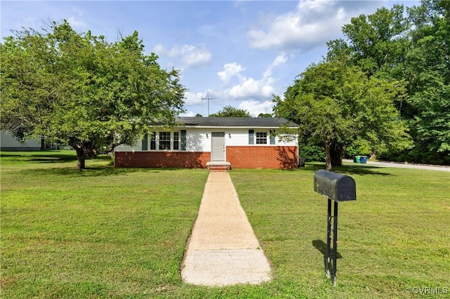 1909 Dinwiddie Ave, Hopewell, VA 23860 - view of front of house with a front yard and brick siding