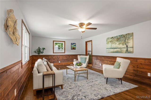 1909 Dinwiddie Ave, Hopewell, VA 23860 - living area with a wainscoted wall, wood walls, wood finished floors, and a ceiling fan