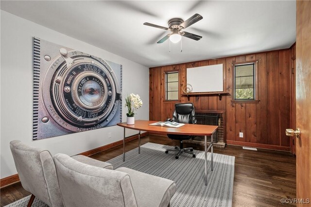 1909 Dinwiddie Ave, Hopewell, VA 23860 - home office with a ceiling fan, wooden walls, and dark wood-type flooring