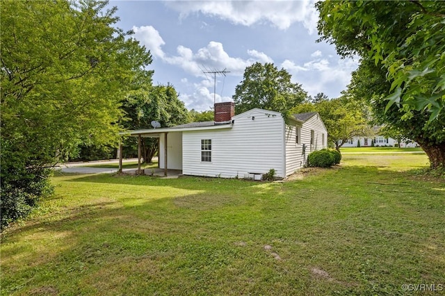1909 Dinwiddie Ave, Hopewell, VA 23860 - view of side of property with a lawn and a chimney