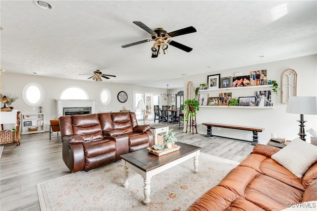 living room with a textured ceiling and wood finished floors