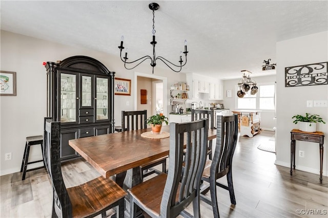 dining room with baseboards and light wood-style flooring