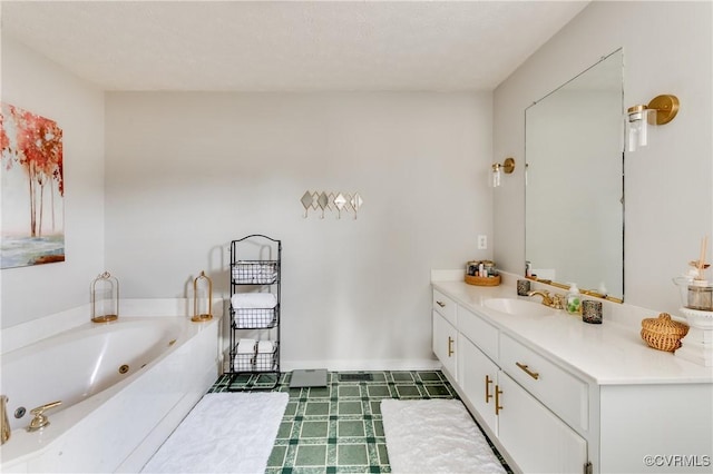 bathroom featuring vanity, baseboards, and a whirlpool tub