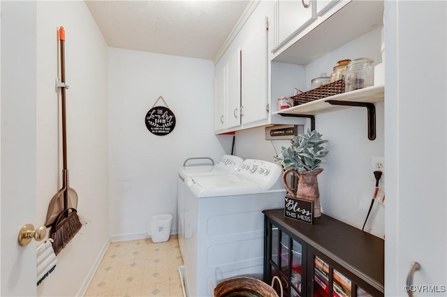 laundry area featuring cabinet space, independent washer and dryer, light floors, and baseboards