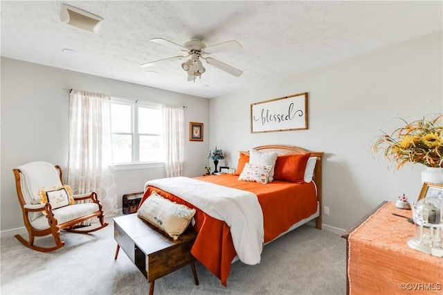 bedroom featuring baseboards, a textured ceiling, ceiling fan, and carpet floors