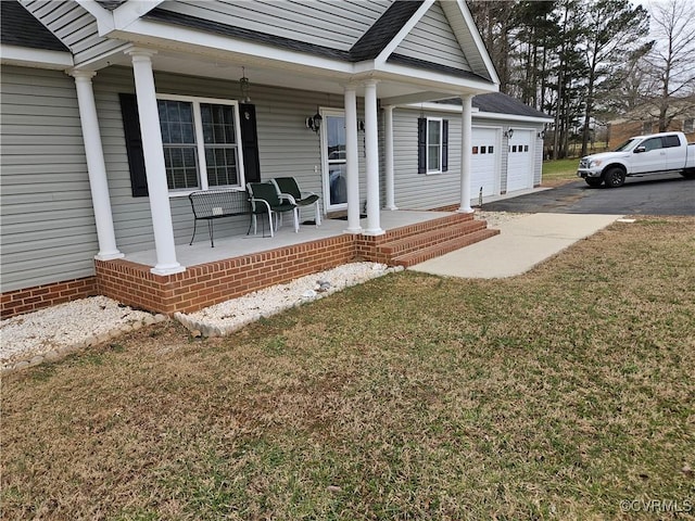 property entrance featuring a porch, an attached garage, driveway, roof with shingles, and a lawn