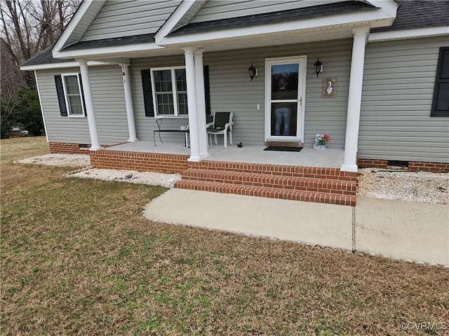 entrance to property with crawl space, a porch, a lawn, and roof with shingles