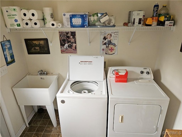 washroom with laundry area, dark tile patterned flooring, independent washer and dryer, and baseboards