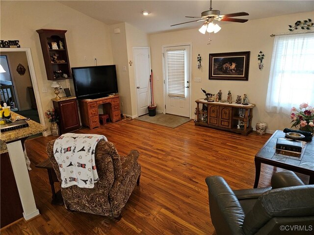 living room with baseboards, a ceiling fan, and wood finished floors