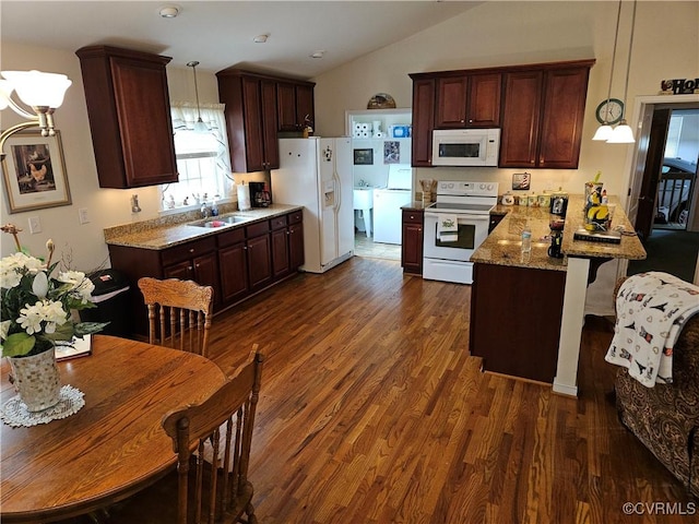 kitchen with dark wood-style flooring, a sink, vaulted ceiling, white appliances, and a peninsula