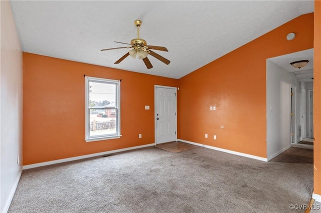 unfurnished room featuring lofted ceiling, carpet floors, ceiling fan, and baseboards