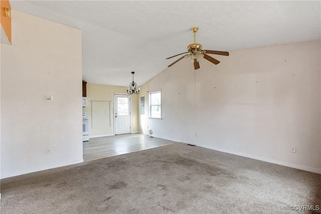 unfurnished room with ceiling fan with notable chandelier, vaulted ceiling, carpet, and baseboards