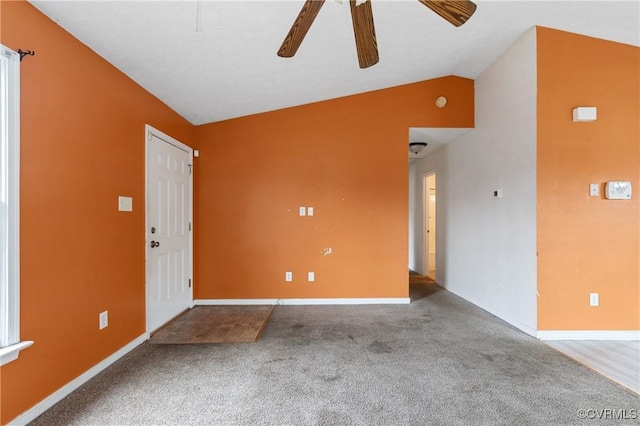 interior space featuring vaulted ceiling, baseboards, and ceiling fan