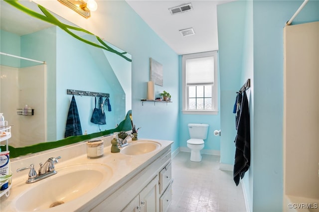 bathroom featuring visible vents, walk in shower, and a sink