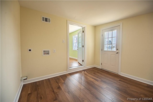 entryway featuring dark wood-type flooring, visible vents, and baseboards