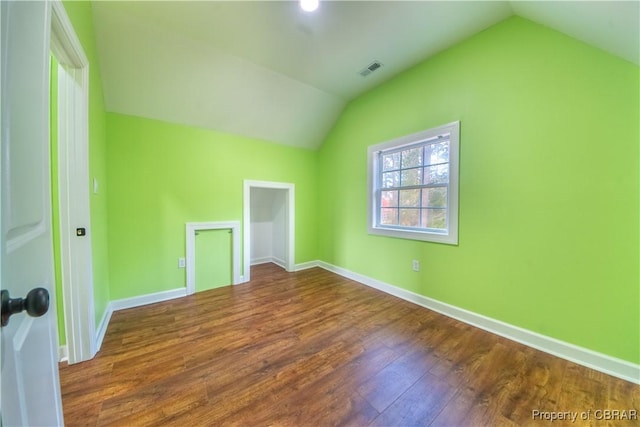 bonus room featuring vaulted ceiling, baseboards, and wood finished floors