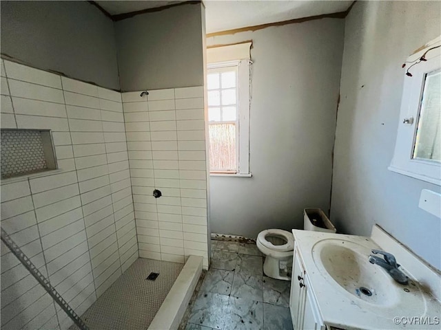 bathroom with toilet, marble finish floor, a shower stall, and vanity