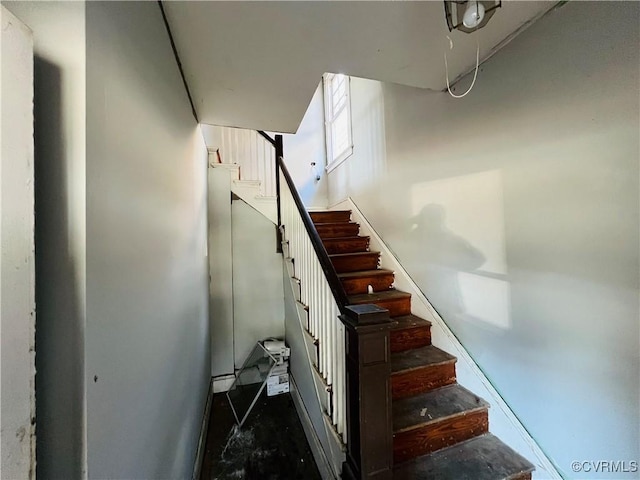 staircase featuring concrete flooring