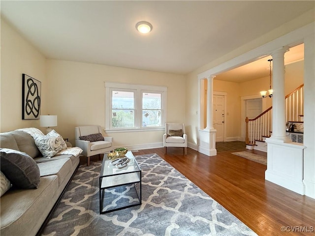 1934 Wood St, Richmond, VA 23223 - living room featuring stairway, decorative columns, wood finished floors, and baseboards