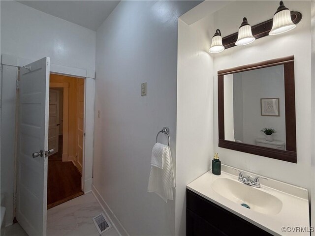 1934 Wood St, Richmond, VA 23223 - bathroom with visible vents, baseboards, marble finish floor, and vanity