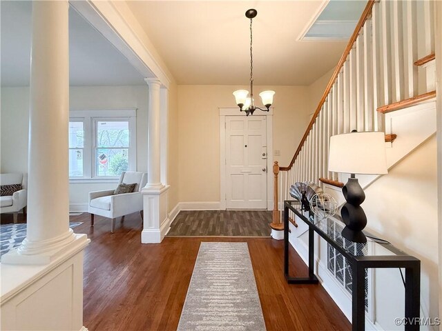 1934 Wood St, Richmond, VA 23223 - entrance foyer with dark wood-type flooring, stairway, an inviting chandelier, decorative columns, and baseboards