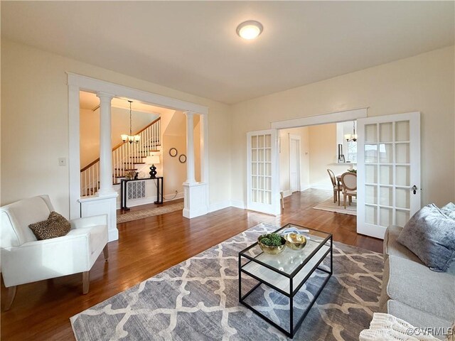 1934 Wood St, Richmond, VA 23223 - living room featuring wood finished floors, baseboards, decorative columns, stairs, and french doors
