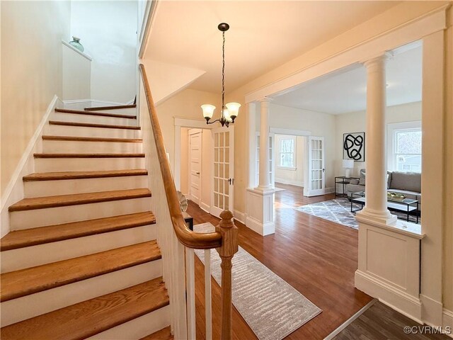 1934 Wood St, Richmond, VA 23223 - stairway featuring french doors, baseboards, wood finished floors, and ornate columns