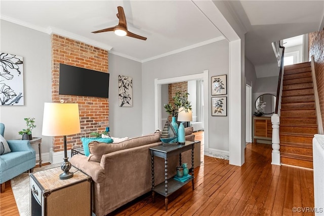 living room featuring stairs, a ceiling fan, wood-type flooring, and ornamental molding