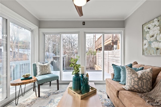 sunroom / solarium featuring ceiling fan