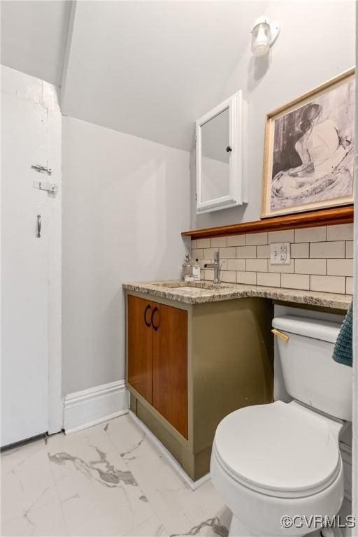 half bathroom with toilet, marble finish floor, backsplash, baseboards, and vanity